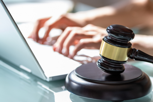 Person sitting at laptop with gavel